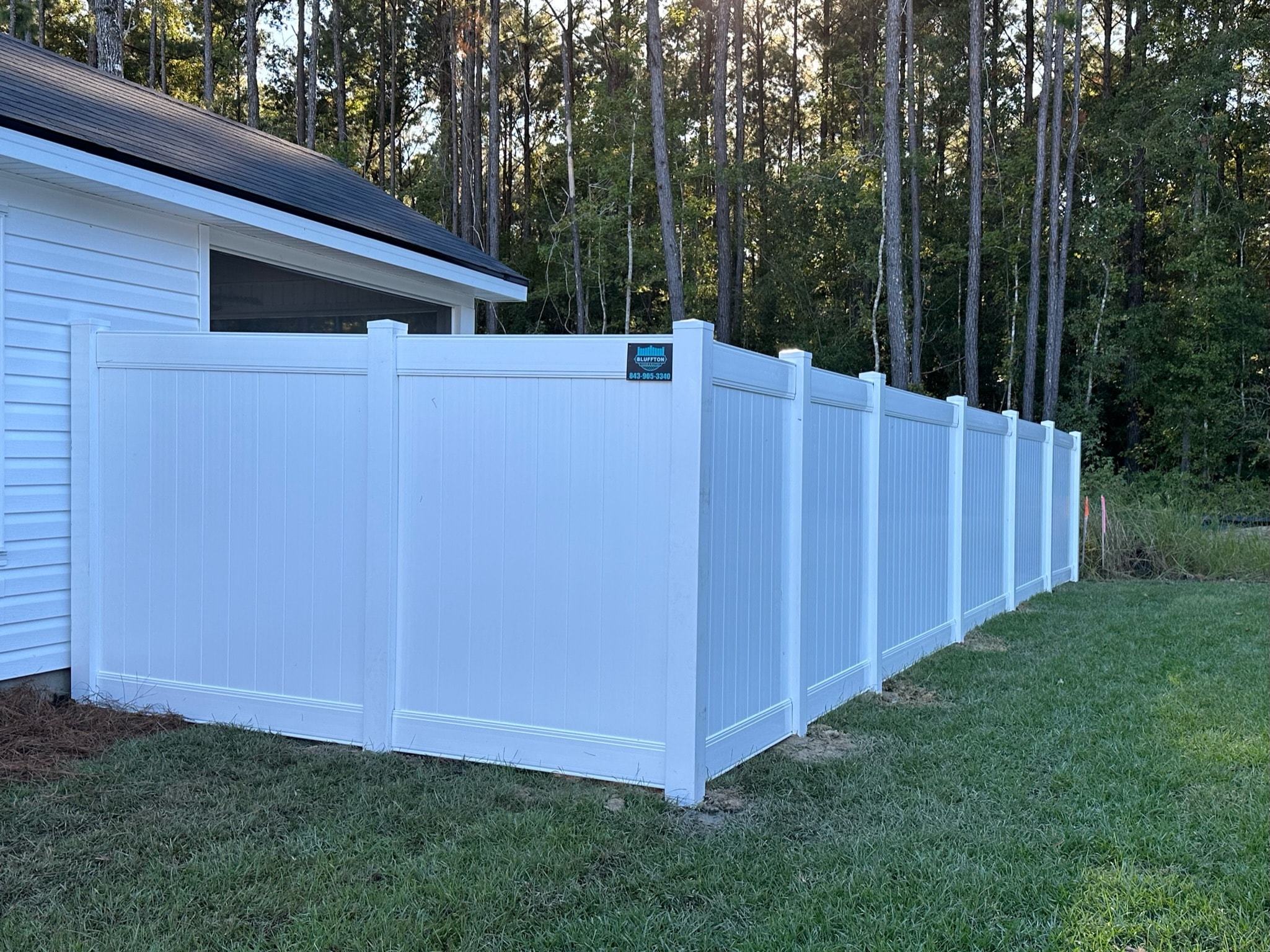 White vinyl privacy fence along residential home