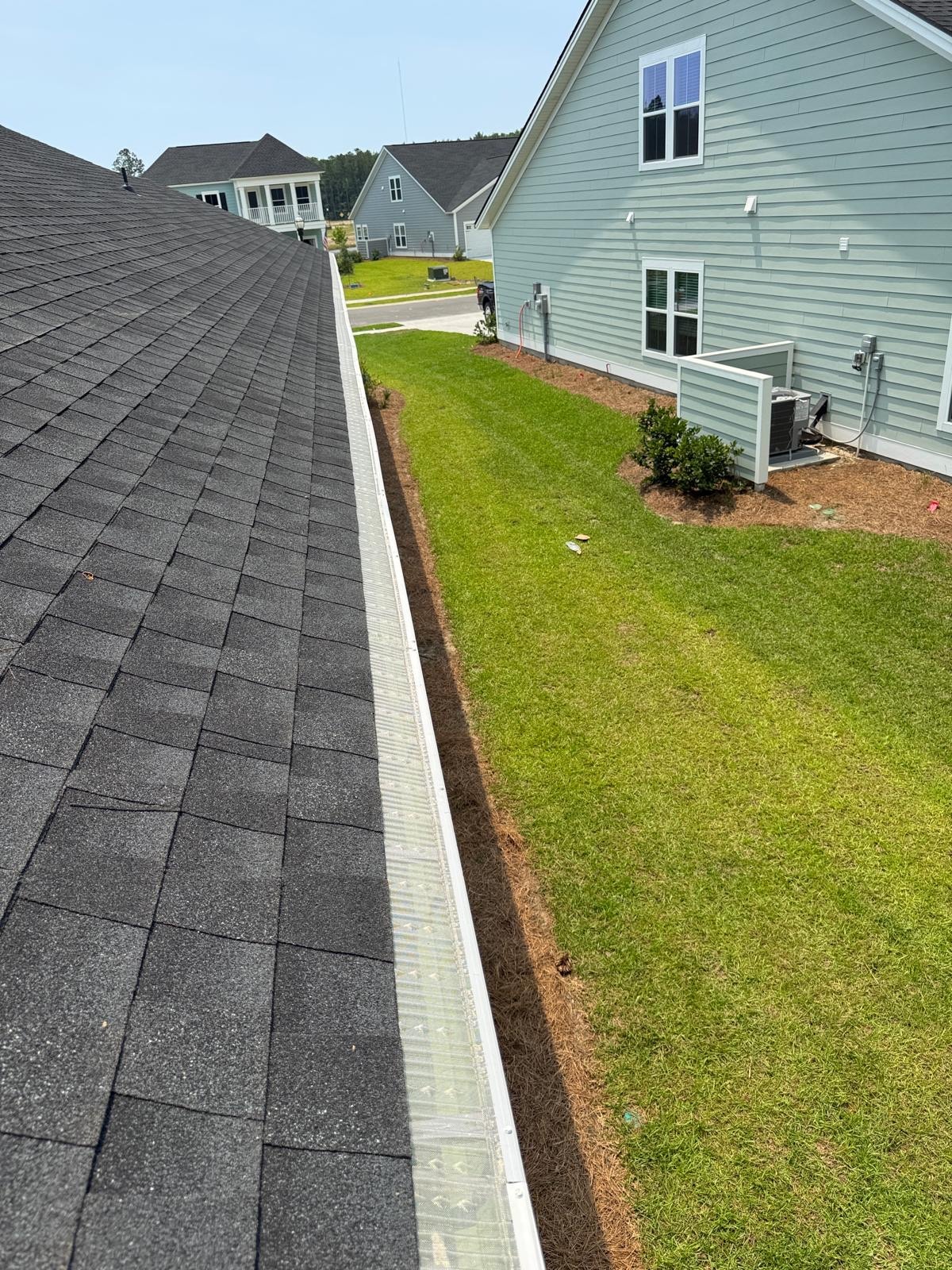 Clean white gutters along residential roofline