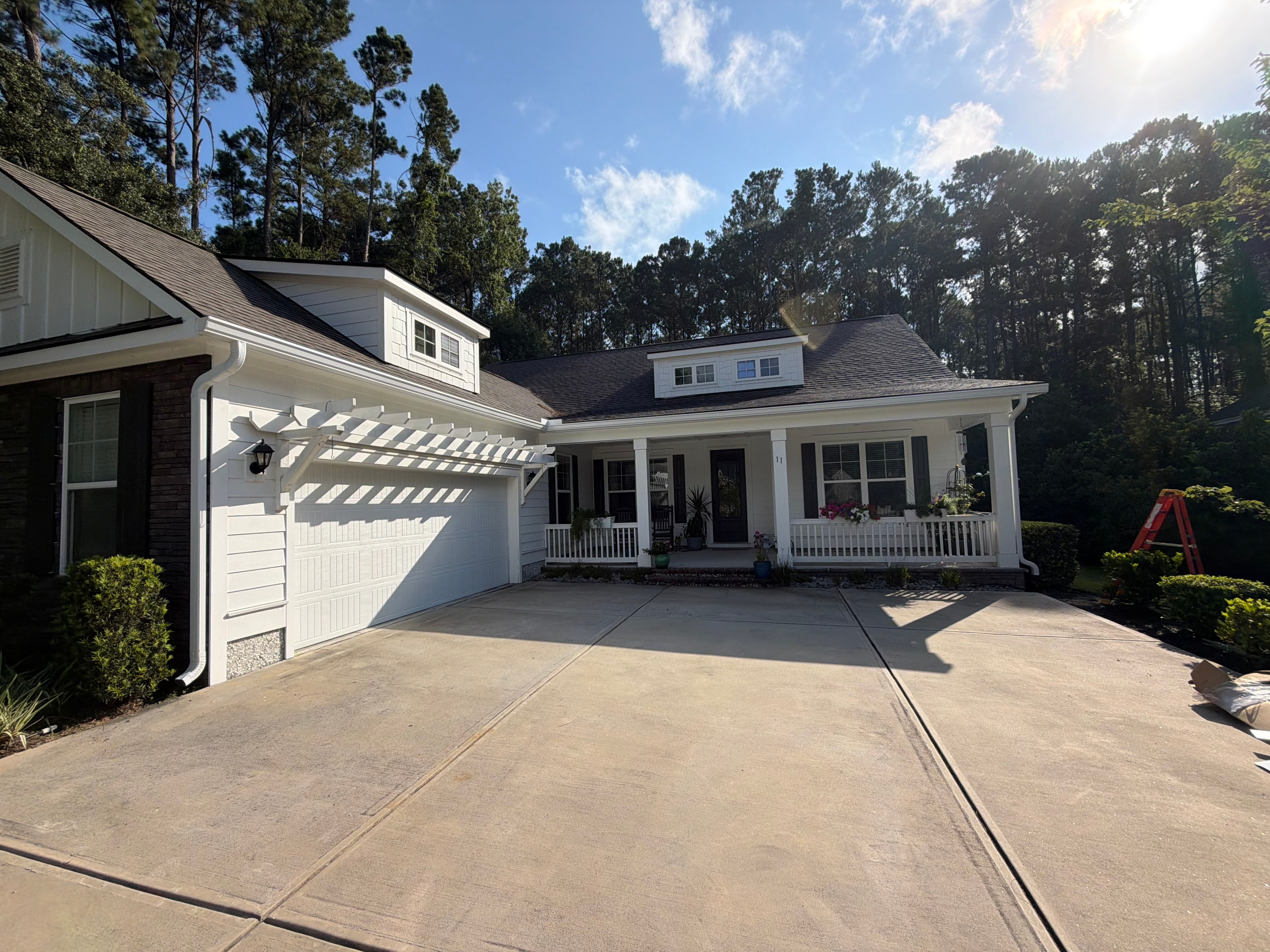 White gutters on charming Lowcountry home with pine trees